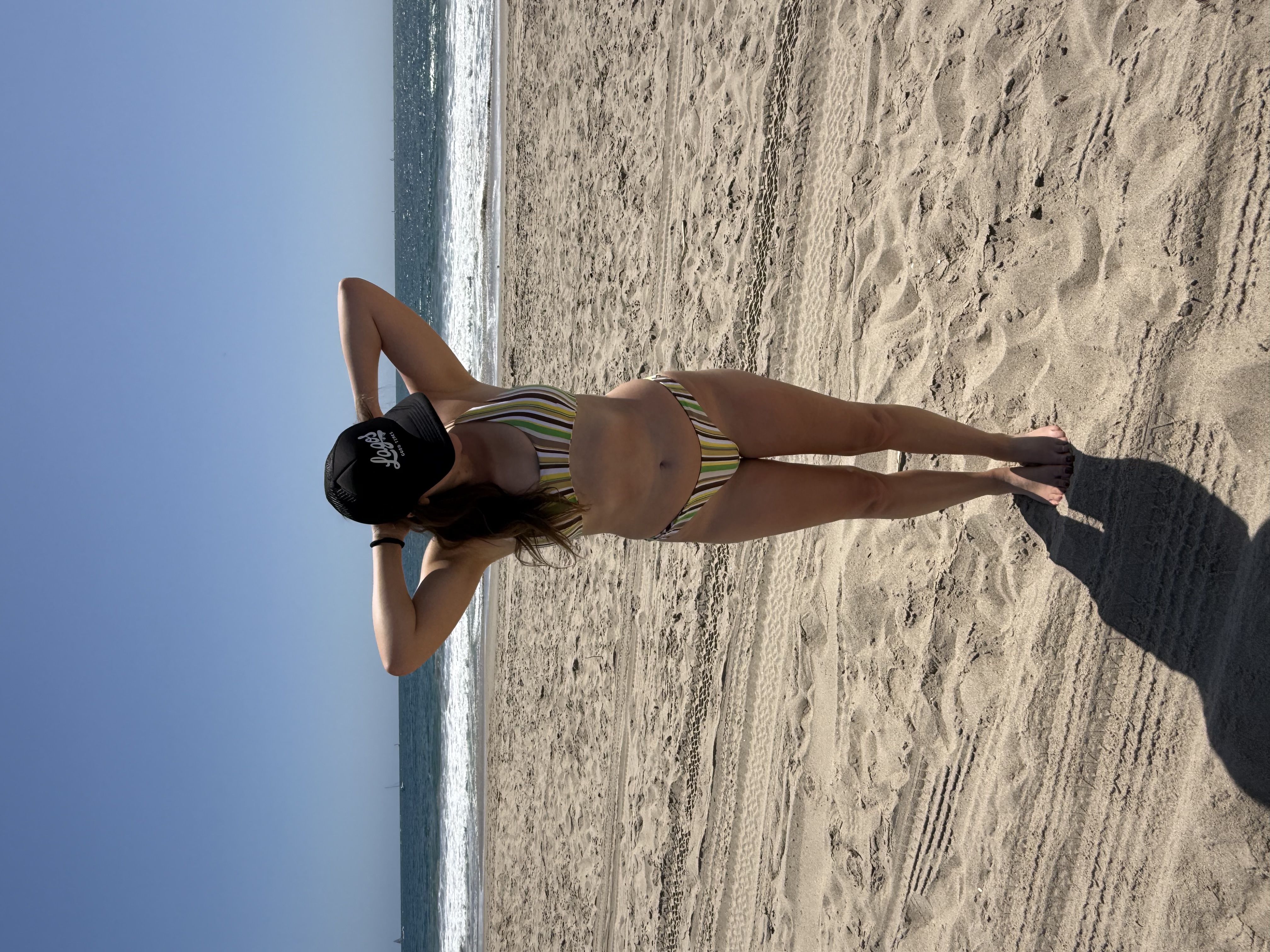 Emily at the beach wearing the finished striped Finley top and Roxy bottoms swimsuit